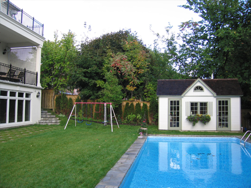 A pool and a house in the backyard.
