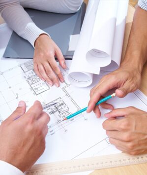 A group of people are working on some plans.